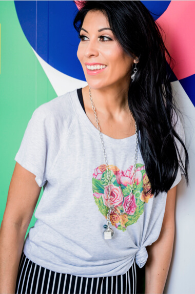 Female model wearing the cabi Botanical Tee in Heather Grey and the ATC Wink Dress in Black & White Stripe