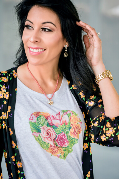 Female model wearing the cabi Botanical Tee in Heather Grey, Debut Dress in Fiesta Floral, and 100% Boyfriend in Super Destructed Wash