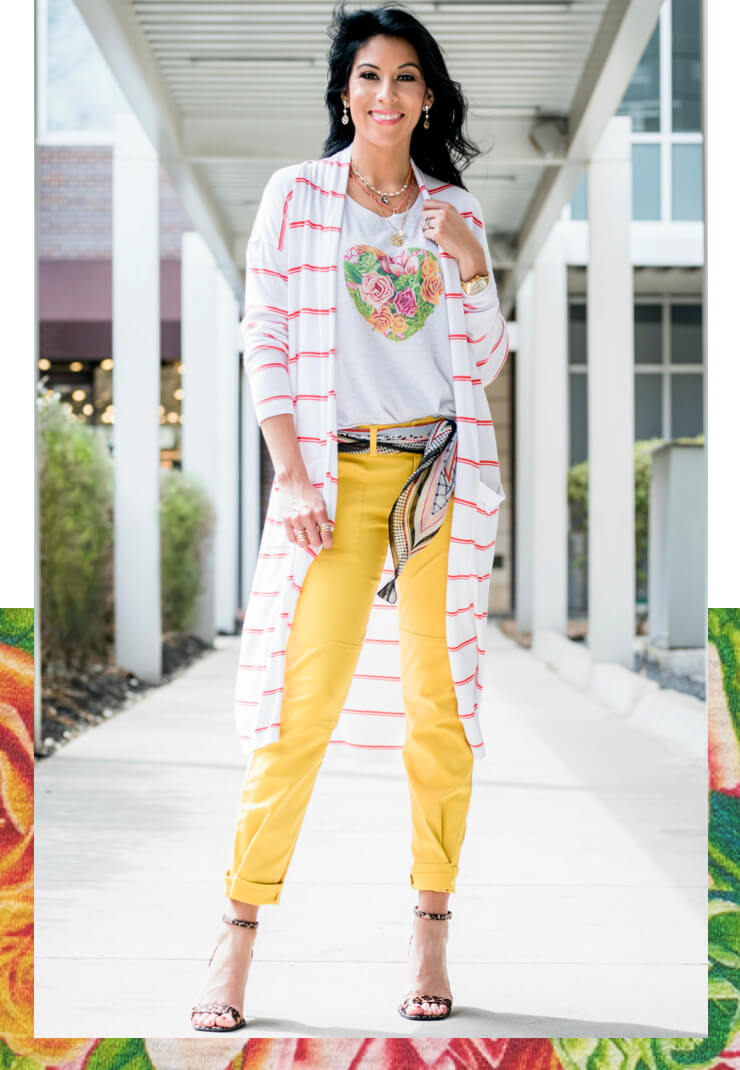Female model wearing the cabi Botanical Tee in Heather Grey, Stroll Cardigan in Summer Stripe, and Utility Trouser in Sulfur