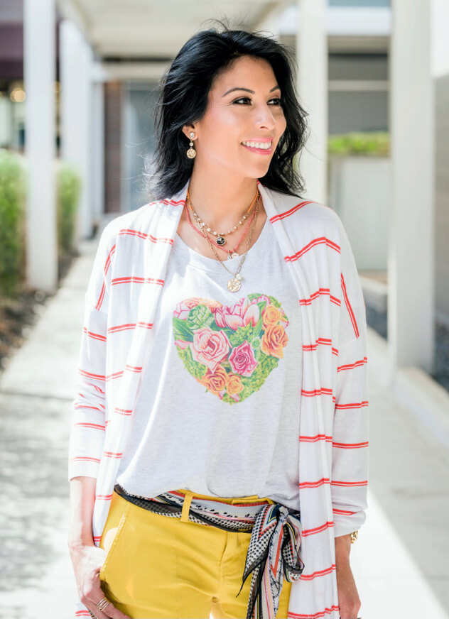 Female model wearing the cabi Botanical Tee in Heather Grey, Stroll Cardigan in Summer Stripe, and Utility Trouser in Sulfur