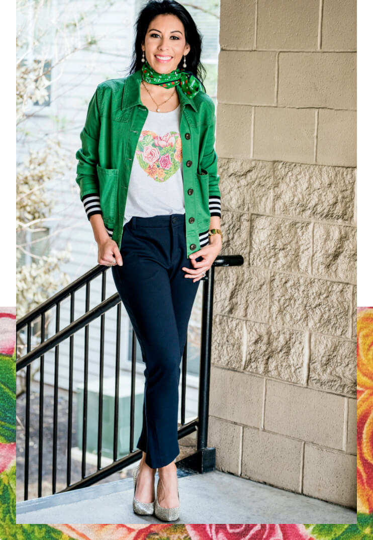 Female model wearing the cabi Botanical Tee in Heather Grey, Mod Bomber in Grass, and the Pencil Trouser in Classic Navy