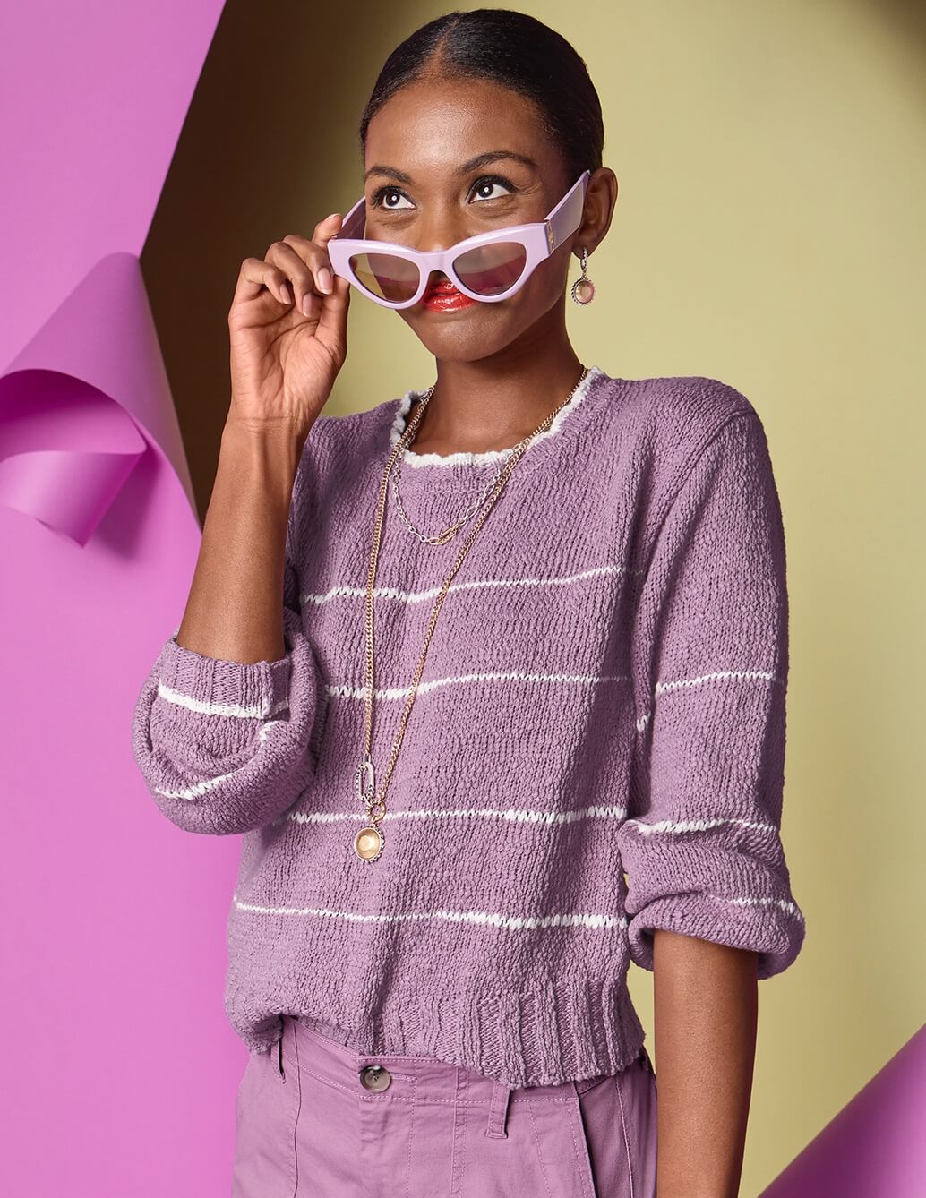 Model Wearing Heartbeat Pullover in Orchid, Paperback Short in Orchid, Timepiece Necklace in Silver and Gold, Timepiece Earrings in Silver and Gold.